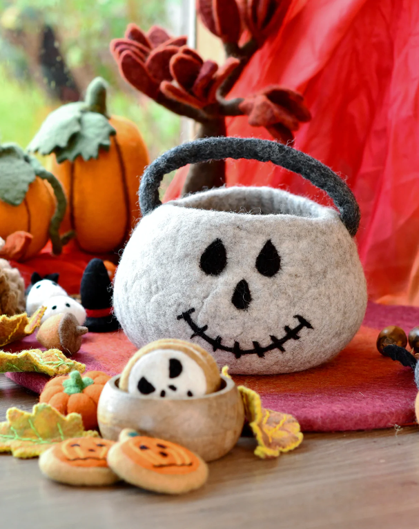 Second view of the felt skull bag showing the stitched eyes and nose