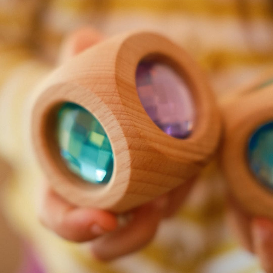 Close-up of the Bauspiel Magic Cube Pastel showing the pastel faceted gems set in alder wood