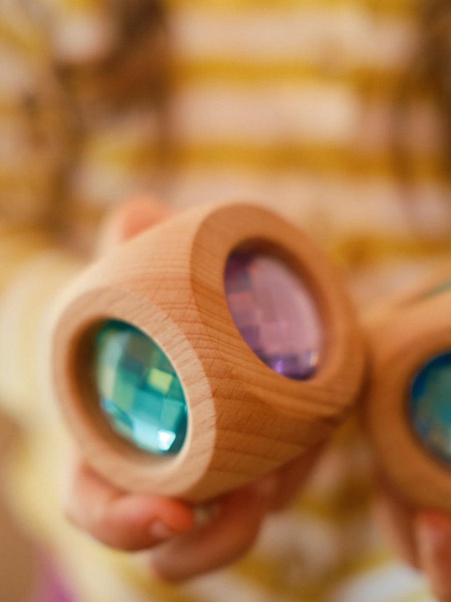 Close-up of the Bauspiel Magic Cube Pastel showing the pastel faceted gems set in alder wood