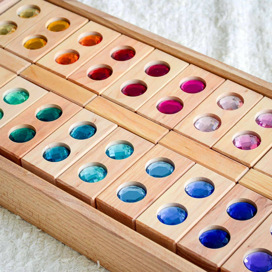 Close-up of Bauspiel Color Track gem blocks with faceted stones in rainbow colors