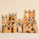 Bauspiel Large Fairytale Castle, all 16 pieces arranged as a tall castle with staircases, keyhole walls and gem-set towers · view 2