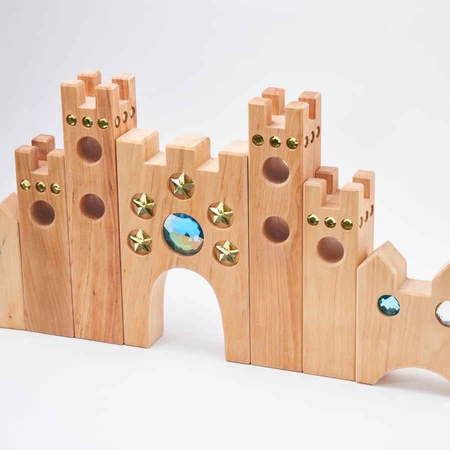 Side view of the Bauspiel Small Fairytale Castle showing tall towers with gold star and blue gem insets