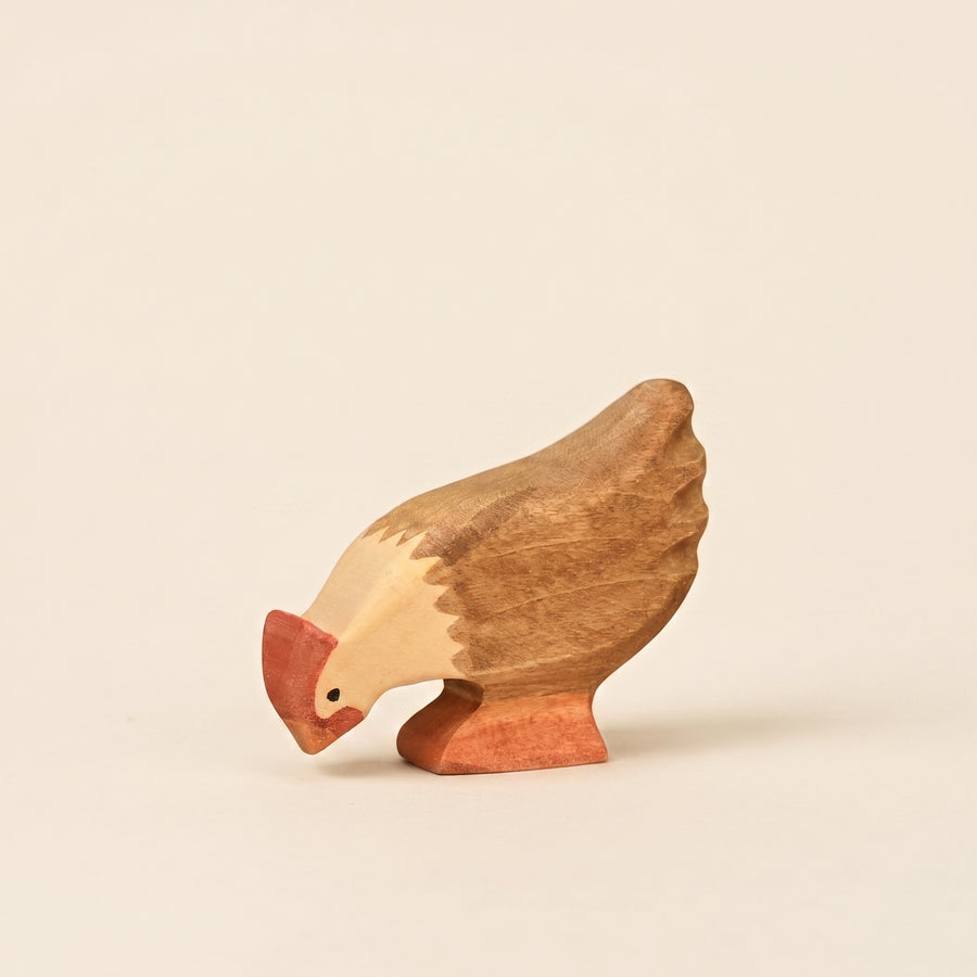 Mako Toys wooden hen with its head lowered to peck, painted brown and cream with a red comb