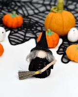 Close view of the cloaked witch peg doll showing the felt and the birch body · view 5