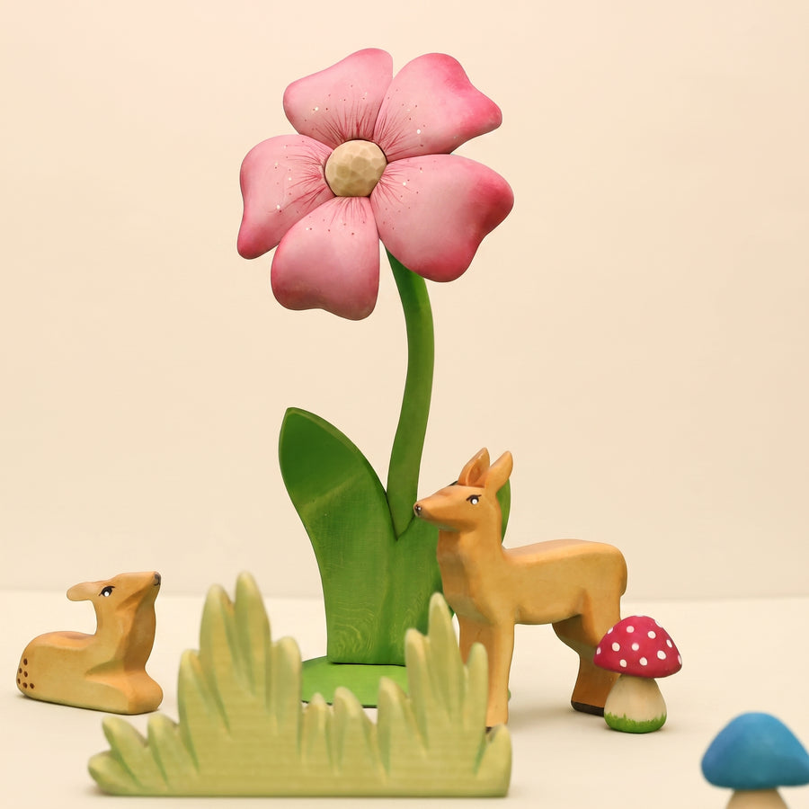 Second view of the wooden flower showing the carved petals and green leaves