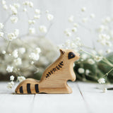 Wooden Baby Raccoon, Sitting, a natural wood animal toy by Tiny Fox Hole, cut and finished by hand from solid wood · view 1