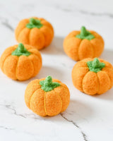 Second view of the felt pumpkins showing their rounded ribbed shape · view 2